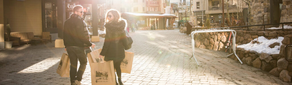 A couple shopping in The Village at Palisades Tahoe.